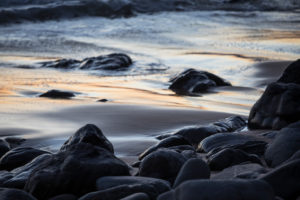 Stones on the beach Praia da Arrifana in the evening light, Atlantic Ocean, Aljezur, Costa Vicentina, Algarve, Faro district, Portugal Stones on the beach Praia da Arrifana in the evening light, Atlantic Ocean, Aljezur, Costa Vicentina, Algarve, Faro district, Portugal